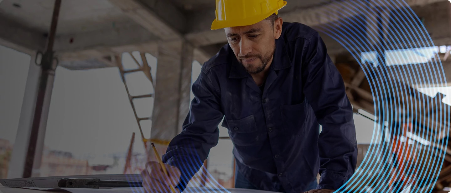 Construction worker in yellow helmet, symbolizing support for builders and integrators using myQ smart access solutions