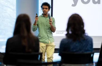 Intern delivering a technical presentation in front of a live corporate audience