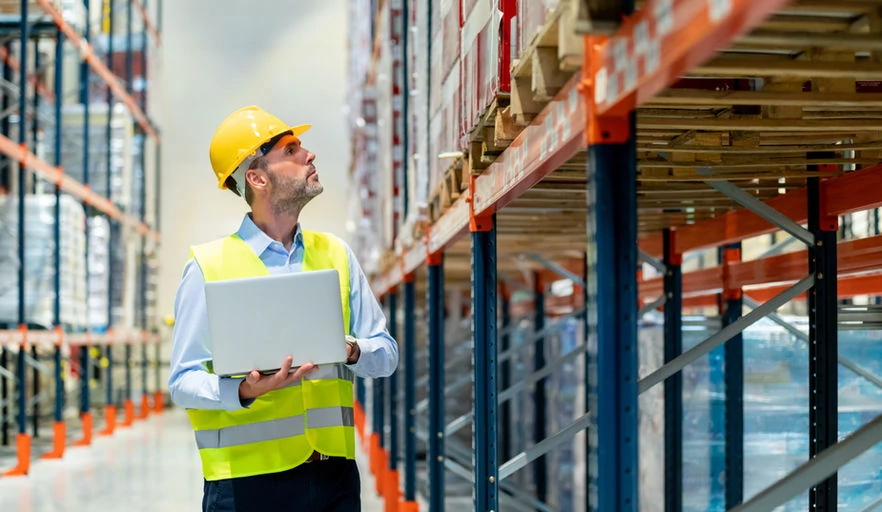 Logistics workers holding tablets in yard