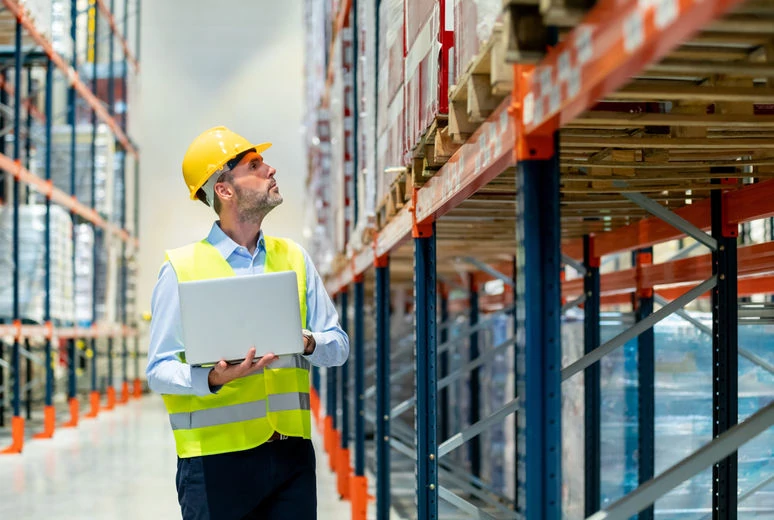 Logistics workers holding tablets in yard